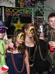 Lovely faces behind colorful mask are hidden at mardi gras party